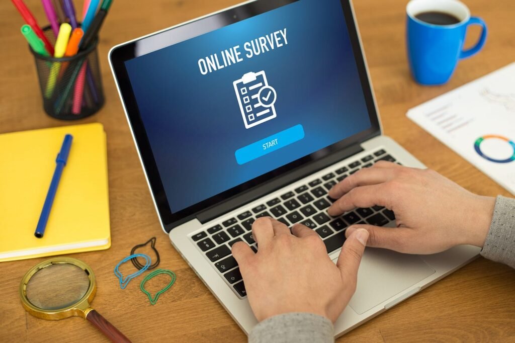 Person completing online surveys to earn money on a laptop
