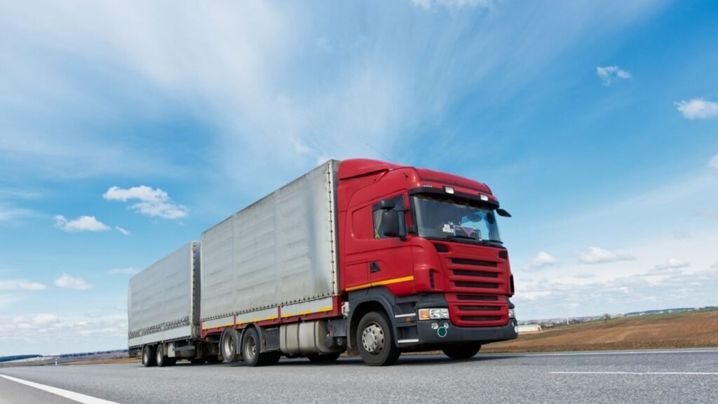 Truck on highway representing earned freight coverage protection for carriers
